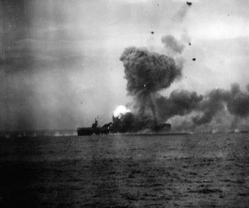 USS St. Lo (CVE-63) burning Taken from USS Kalinin Bay (CVE-68). This view shows the moments after the second explosion