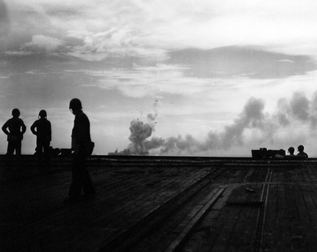 USS St. Lo (CVE-63) burning taken from USS Kalinin Bay (CVE-68). Sailors viewing the moments after the second explosion