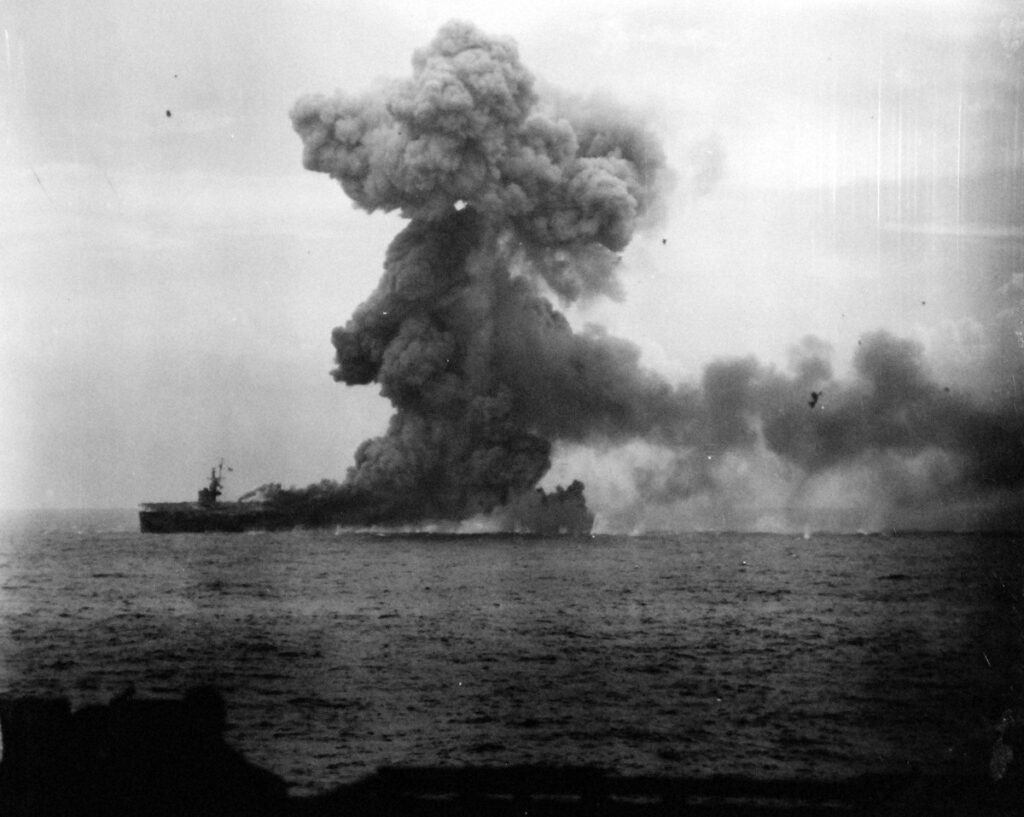 USS St. Lo (CVE-63) shown immediately after being hit by a Japanese suicide plane taken from USS Kalinin Bay (CVE-68)