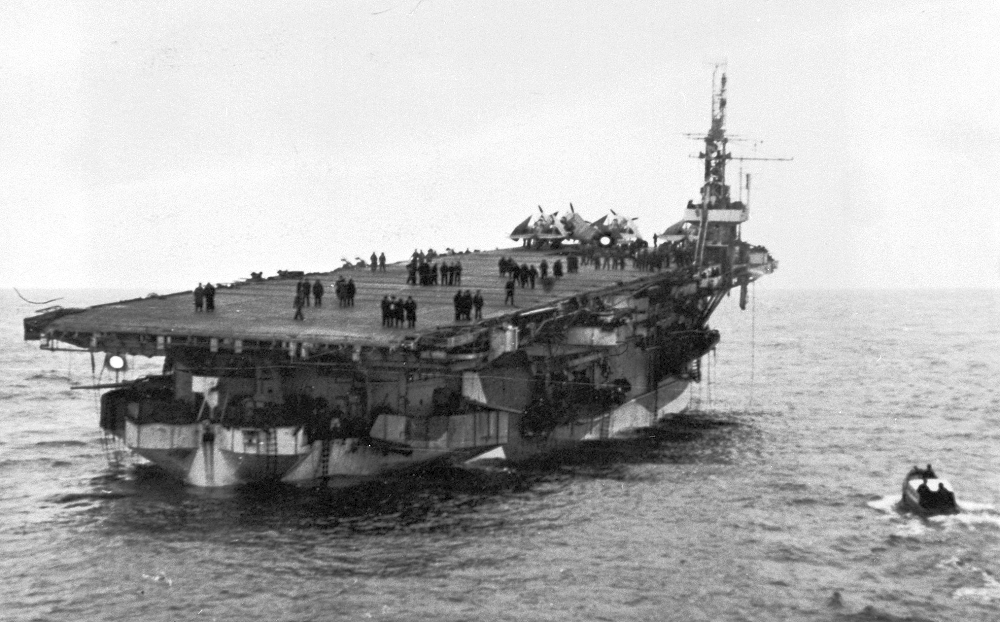 HMS Nabob dead in the water, listing to starboard and down by the stern after being torpedoed August 22nd 1944