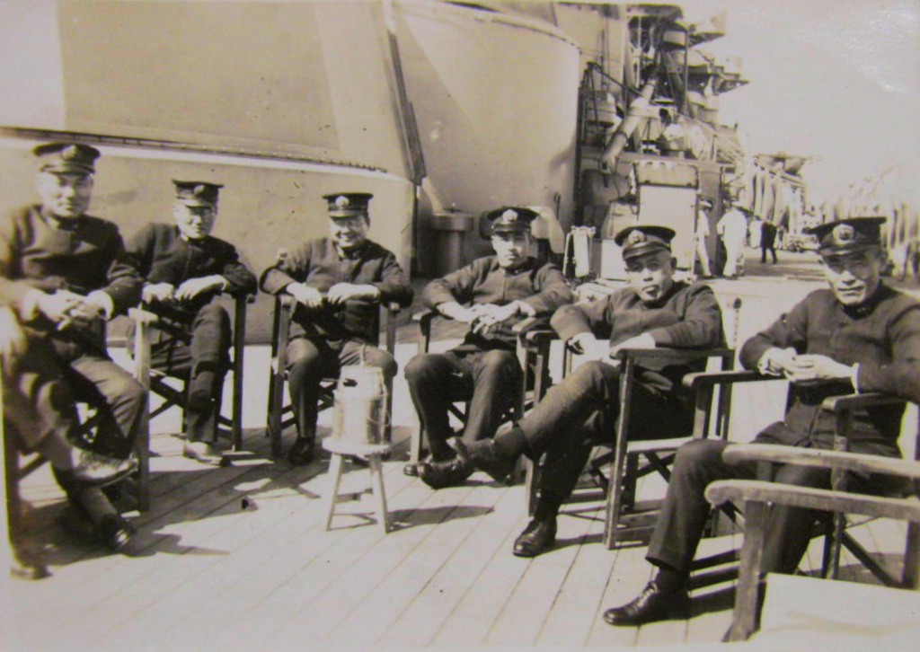 Captain (later Rear Admiral) Machida Shinichiro with subordinates on the deck of Hyuga