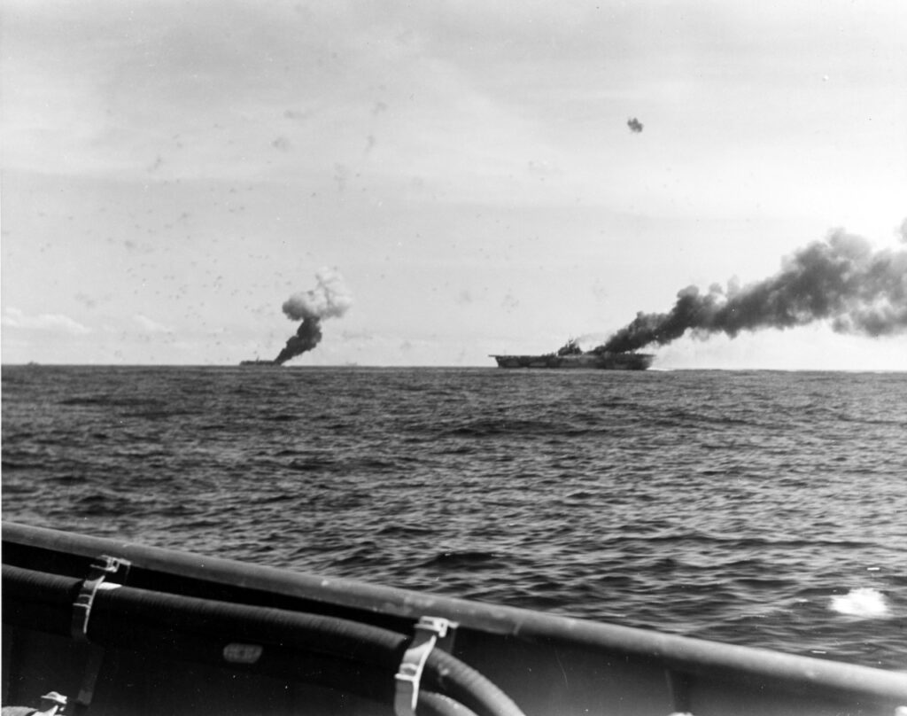 USS Franklin (CV-13), at right, and USS Belleau Wood (CVL-24) afire after being hit by Japanese kamikaze suicide planes,