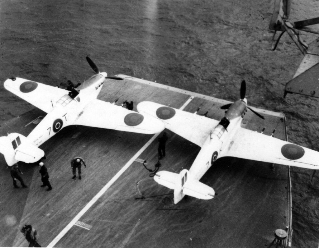 Sea Hurricanes NF700 ('7T') and NF672 ('7K') parked on the front of the flight deck of HMS Nairana during the squadron work up period, C. January 1944