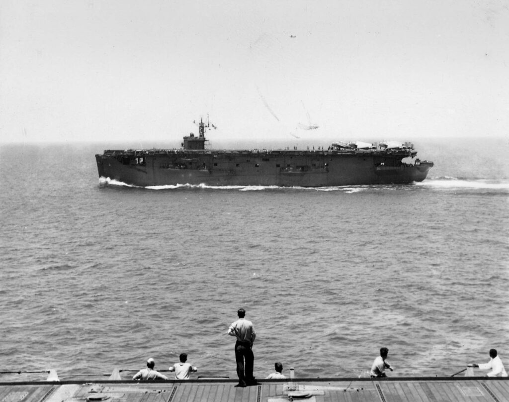 Port broadside photo of USS Nassau (ACV-16) underway on 12 December 1942, in the South Pacific