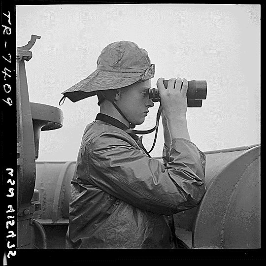 SN2 Lawrence Britton on duty at port lookout aboard USS Nassau (CVE-16), October 1943