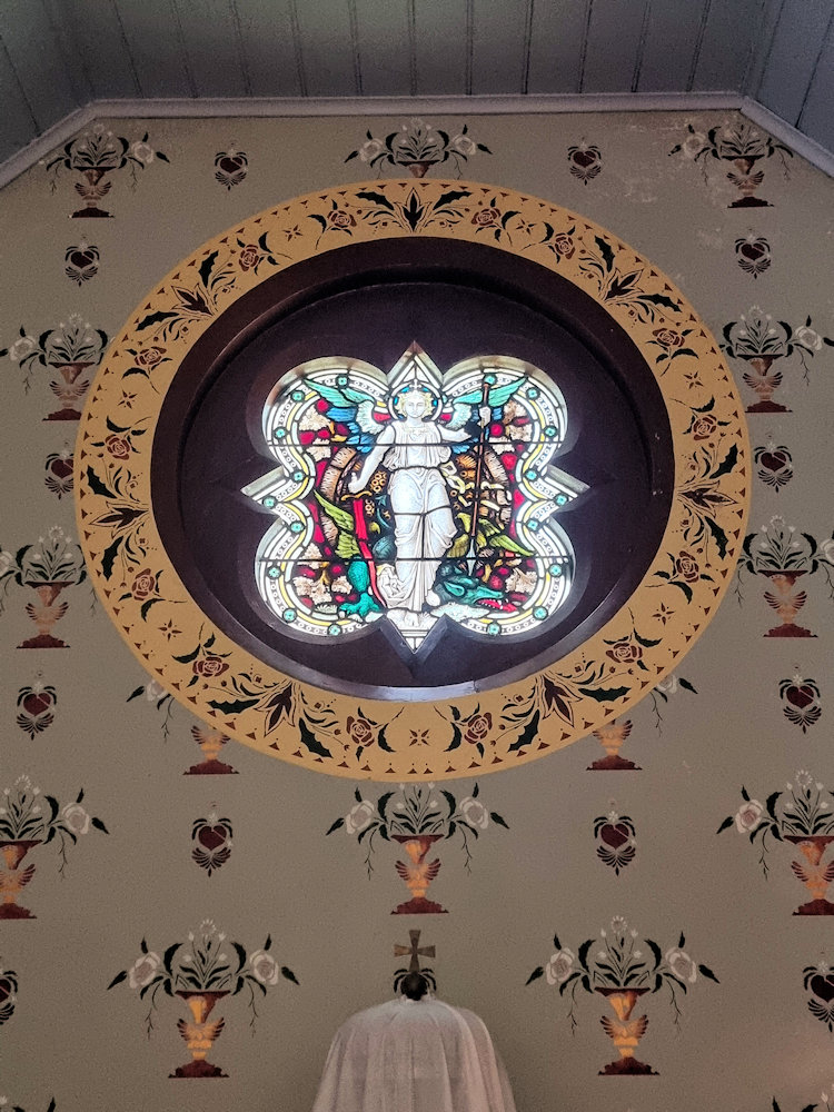 Stained glass window of the Archangel Michael over the altar